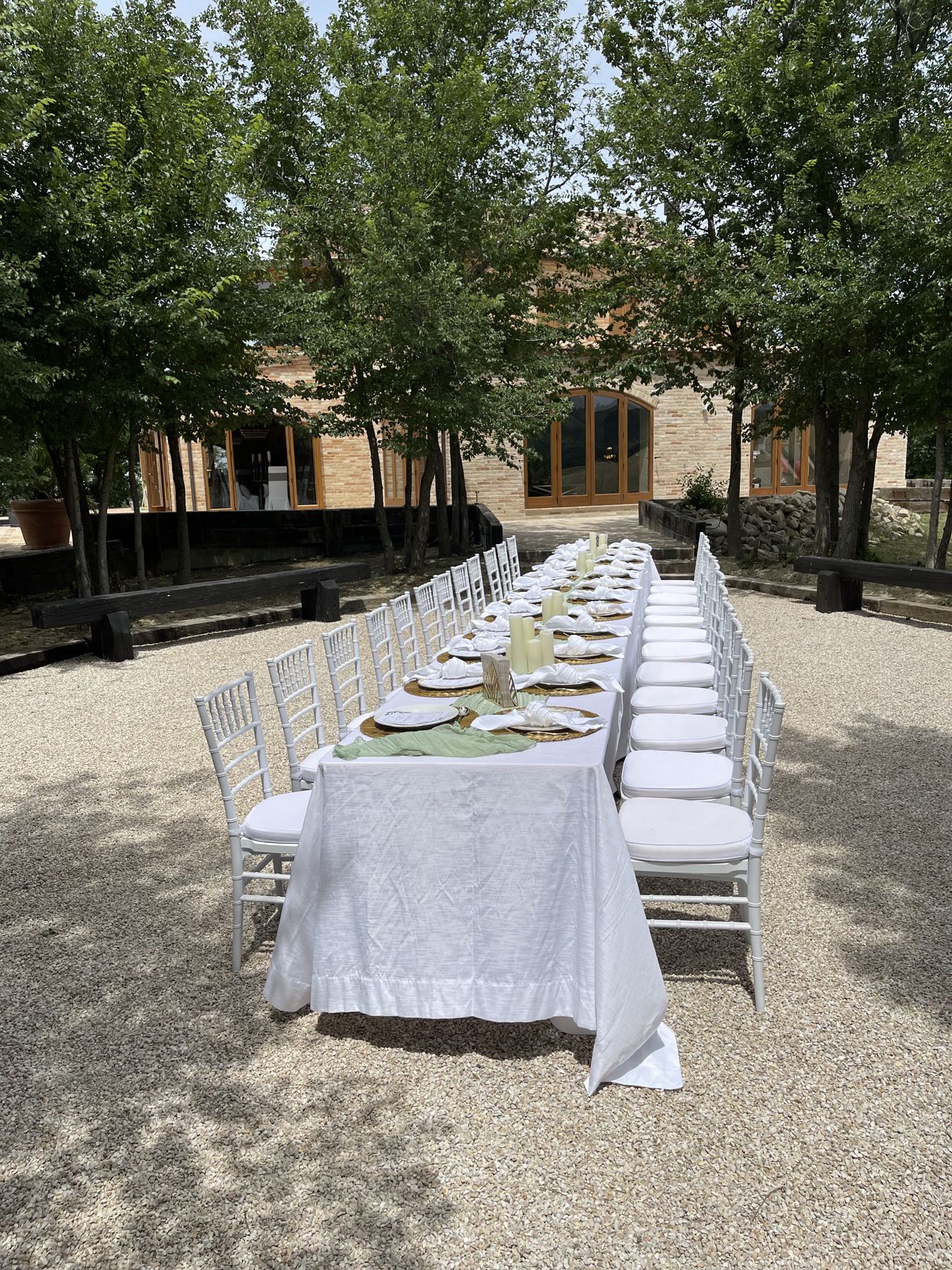 A long table set under the trees