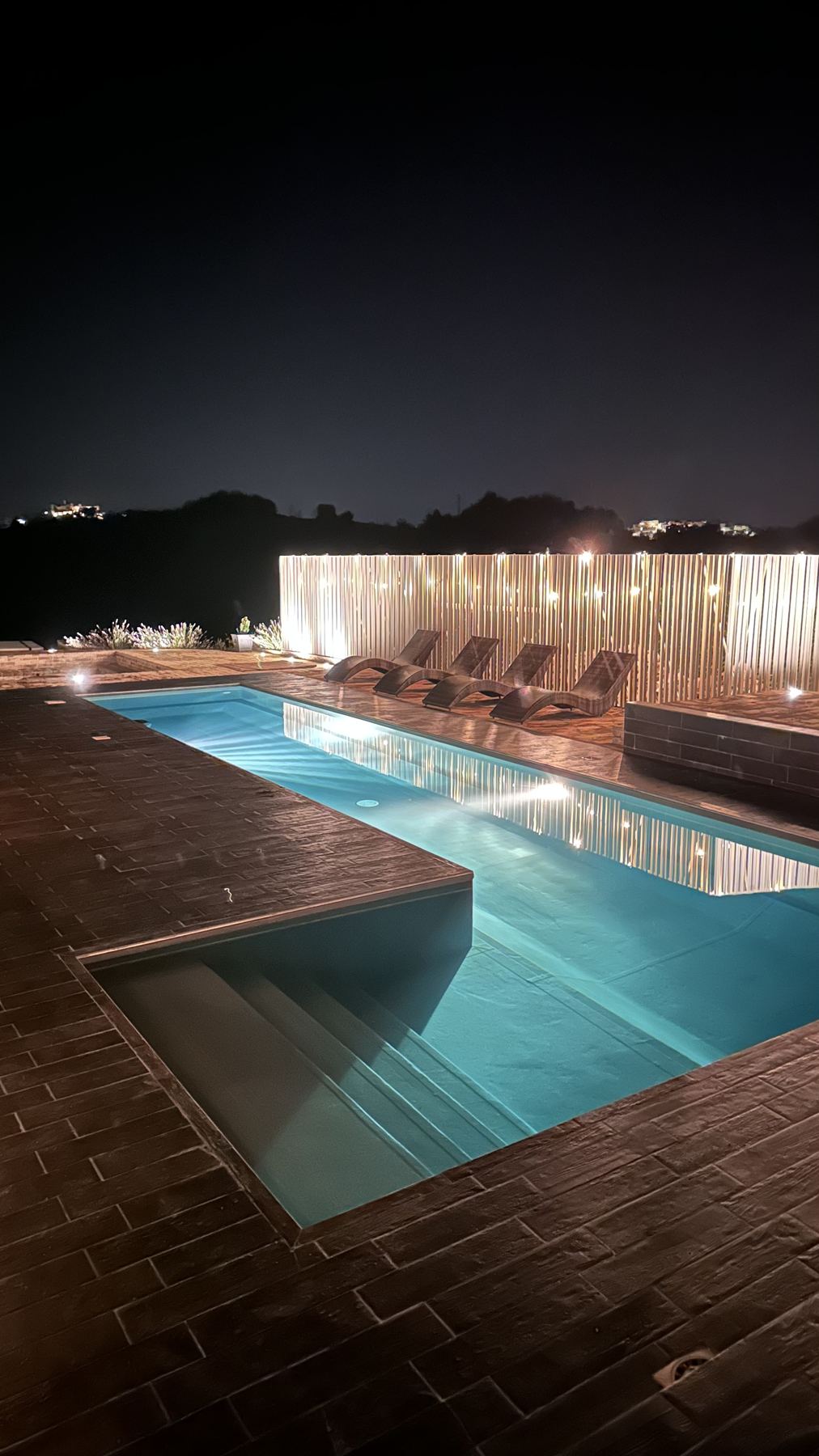 The pool lit at night