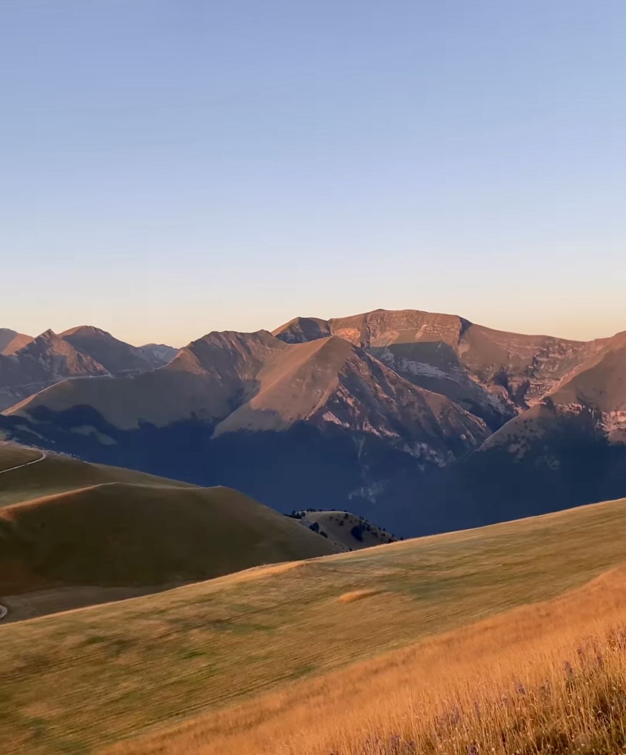 The Sibillini mountains and golden upland meadows at sunset